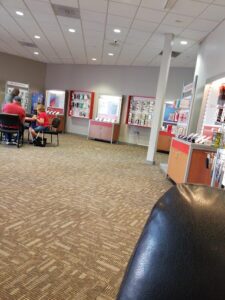 Apple Valley, California Verizon store interior with sales representative assisting a customer. 